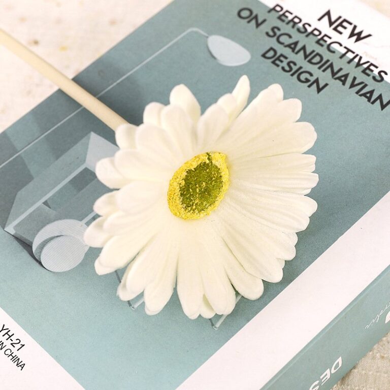 White faux Gerbera daisy flower with yellow glitter center on a stick, perfect for crafts and decor.