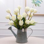 Artificial silk white tulips bouquet arranged in a distressed enamel farmhouse vase.