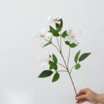 Artificial silk clematis flower arrangement with green leaves, ideal for everlasting home decor.