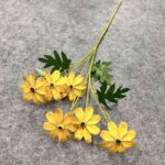 Artificial yellow silk daisy heads with green foliage bouquet for home decor.