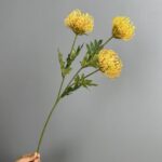 Bunch of yellow pincushion artificial flowers perfect for wedding or home decor arrangements.