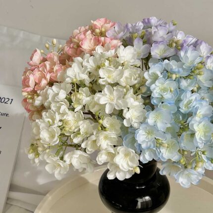Lush silk jasmine bouquet with realistic blush pink, white, and blue artificial flowers for home decor.