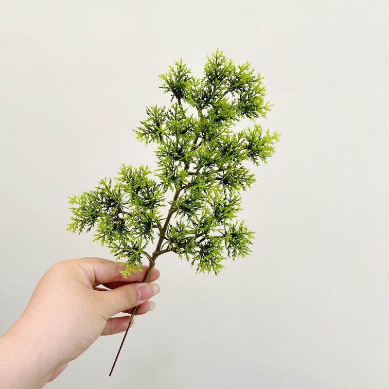Realistic green artificial foliage stems suitable for wedding decorations or indoor home decor.