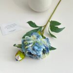 Blue silk peony bouquet with leaves and small inspirational notes for home decor