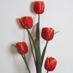 Set of five artificial red silk tulips for home decor arrangement.