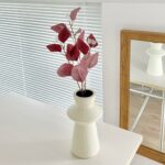 Decorative vase featuring burgundy silk autumn leaves and floral arrangement for indoor home decor.