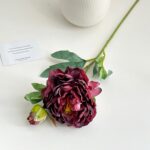 Burgundy silk peony bouquet display with romantic quote card and greenery.