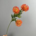 Three heads of realistic artificial pincushion flowers perfect for wedding centerpieces or faux home decor accents.