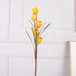 Artificial yellow silk tulips display in a slender vase arrangement for modern home decor