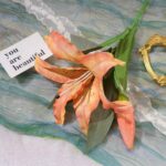 Realistic silk lily bouquet floral arrangement for home decor on marble surface.