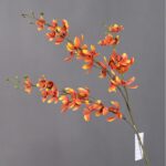 Vibrant artificial silk Vanda orchid arrangement in rich orange and red hues.