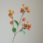 Silk dandelion cluster with green leaves, a beautiful dried botanical bouquet for decor.