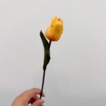 Single realistic faux yellow tulip stem, perfect for artificial wedding or sophisticated home decor arrangements.