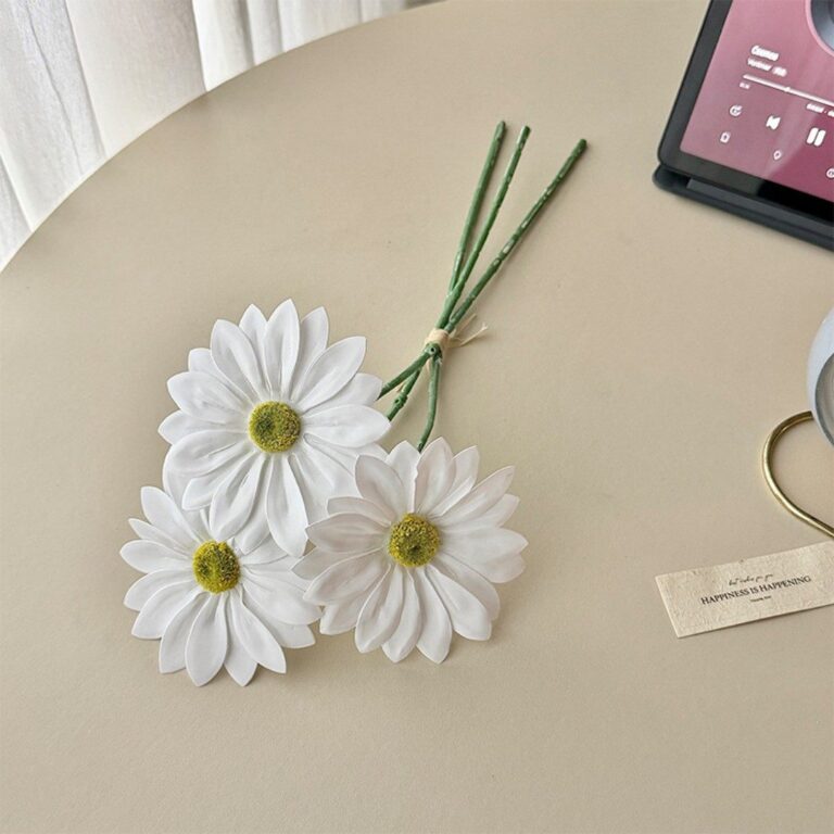Artificial white daisies centerpiece with natural-looking green stems and yellow centers.