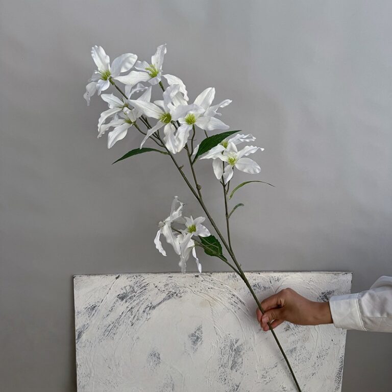 Artificial white lilies branch, featuring 12 realistic fabric flower heads for home decor.