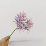 Artificial silk Agapanthus flower arrangement in purple and yellow tones for home decor.