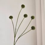 Group of five faux silk green dandelion heads and stems for artificial home decor.