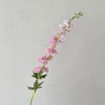 Artificial silk pink delphinium flower spray with green foliage for floral arrangements