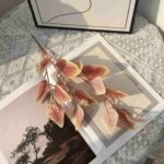 Decorative silk leaf garland arrangement displayed on an open book, perfect for wedding or rustic decor.