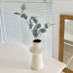 Artificial silk leaf plant in a modern ceramic vase decor display