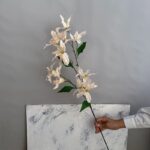 High-quality artificial silk lily arrangement, 12 faux white flower heads for elegant home decor.