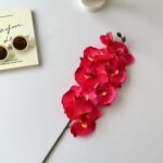 Artificial silk orchid arrangement featuring 8 deep pink blossoms, perfect for home decor