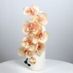Artificial silk orchid bouquet with 8 heads in a vase. Soft peach color floral decor.