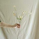 Silk vintage daisy branch with white faux flowers, ideal for delicate floral decor accents