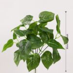 Artificial green foliage leaves for home decor and crafts, offering realistic plastic plant accents.