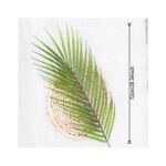 Artificial tropical palm leaves centerpiece displayed on a woven decorative base for home decor.