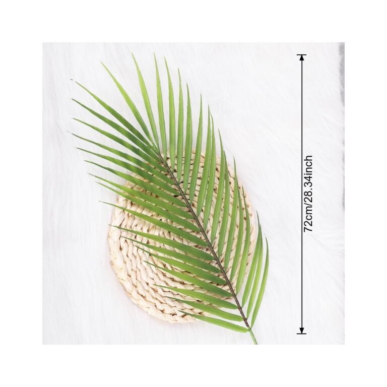 Artificial tropical palm leaves centerpiece displayed on a woven decorative base for home decor.