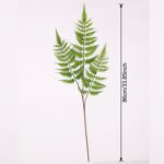 Artificial hanging green foliage arrangement with faux fern branches attached to a PVC stem.