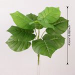 Artificial PVC foliage set of lush green jungle leaves on sticks for realistic home decor.