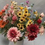 Vibrant bouquet of realistic silk daisies and mixed colored blooms for wedding or home decor.