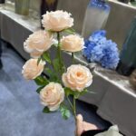 Artificial flower bunch of six creamy silk rose heads for elegant, everlasting décor.