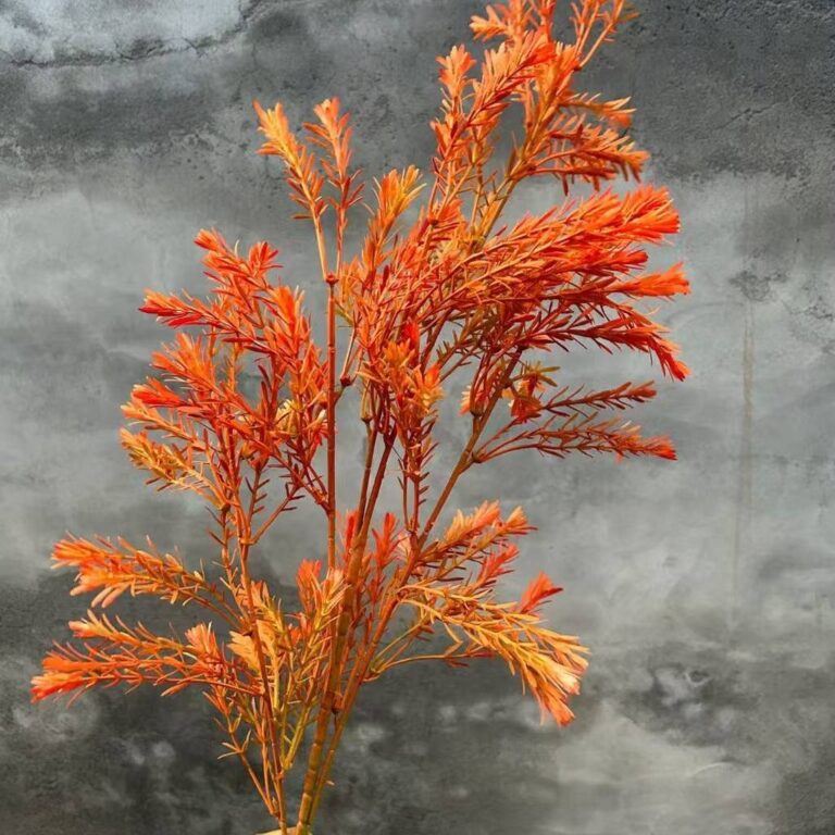 Golden artificial tea tree branch floral arrangement made of realistic silk flower material.