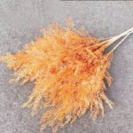 Artificial flower bundle in warm orange tones, ideal for crafting or as silk floral accents.