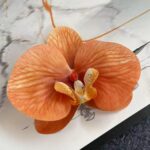 Realistic artificial orange silk orchid bloom head for elegant flower arrangements