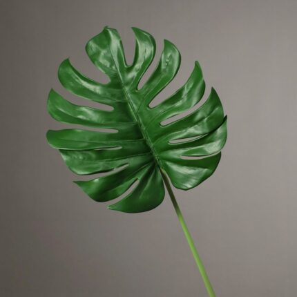 Realistic artificial Monstera deliciosa leaf for home decor using silk flower materials.