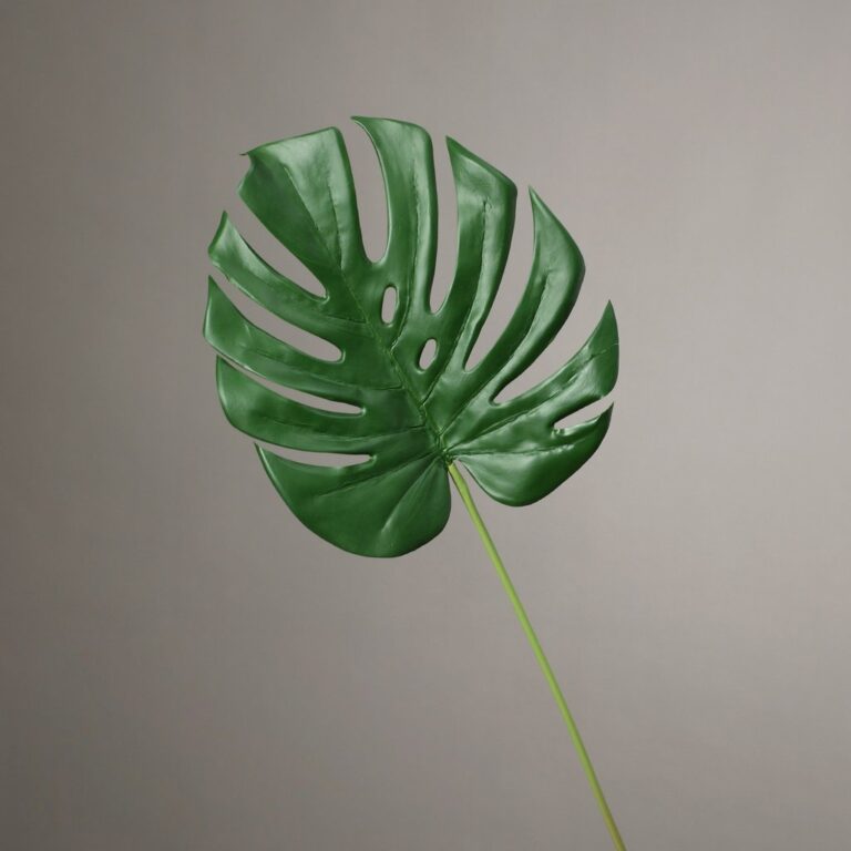 Realistic artificial Monstera deliciosa leaf using premium silk fabric for home decor.
