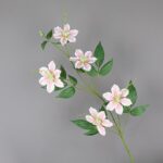 Artificial silk clematis flowers in delicate pink bloom arranged on green stems.