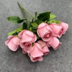 Bouquet of pink artificial flowers; elegant silk flower home decoration.