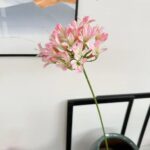 Artificial flower display of pink silk Agapanthus blooms on a long stem for decor.