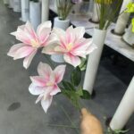 Three delicate pink silk flowers arranged as a bouquet stem, featuring realistic artificial flower petals.