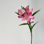 Pink silk lily artificial flower arrangement on green stem decor.
