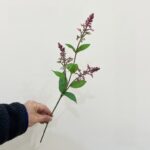 Realistic artificial flower stems featuring lavender blossoms and deep green leaves for crafting.