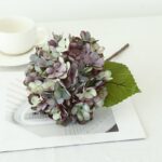 Fake dusty purple silk hydrangea arrangement decor product shot on white.