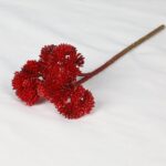 Cluster of bright red artificial silk flower blooms on a stem.