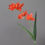 Artificial flower arrangement of vibrant orange Freesia blooms, perfect for home decor.