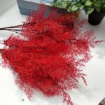 Vibrant bunch of red artificial flower foliage branches for craft decor.